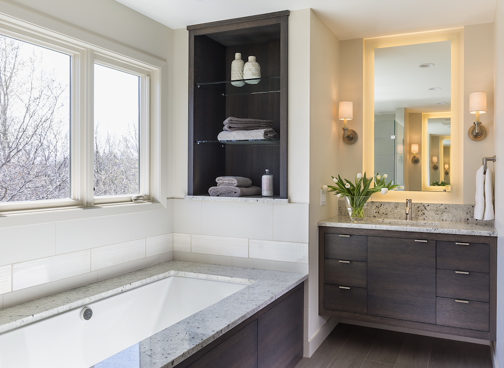 Contemporary bathroom with dark wood vanity and tub surround