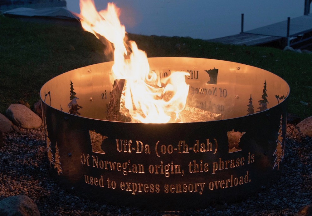 A customized fire pit ring with the definition of Off-Da, trees and the state of Minnesota carved into it.
