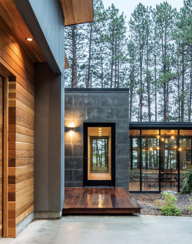 The exterior of a modern home by Strand Design in the north woods.