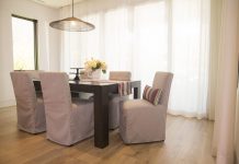 High-Performance Fabrics for Real-Life Homes Dining chairs slipcovered in Sunbrella Frequency Ash. Decorative pillows and runner in Sunbrella Icon Mystique.