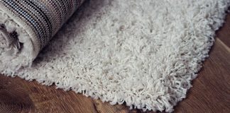 Layering Rugs Layered rugs on a brown floor.