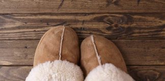 Radiant Floor Heat Sheepskin slippers sitting on a wood floor.