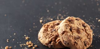 How To Be A Crummy House Guest Two cookies with crumbs surrounding them representing how to be crummy house guest.