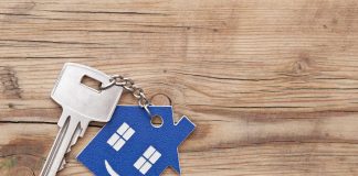 Selling Your House Over The Holidays Keys on a wooden background after selling your house.