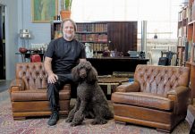 Peter Dyste’s Antique & Real Estate Sales Tips Peter Dyste sitting in a living room on a couch with his dog.