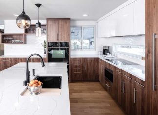 Shelter Architecture A kitchen designed by Shelter Architecture on the 2017 ASID Designer Kitchen Tour. Dark wood cabinetry is accented with white countertops and black appliances.