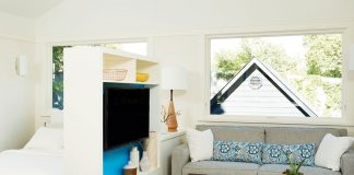 Christopher Strom Architects Wins “Best Contemporary” in Architects Challenge A small living and bedroom separated by shelving.