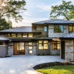 A Prairie-style Home by Bruce Lenzen Design/Build The house shows off its views of the water from every side. Glass doors, metal roof, stucco, and stone make it beautiful as well as low maintenance.