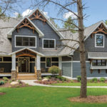 The blue home's exterior gives a lodge feeling that meshes well with the natural surroundings.