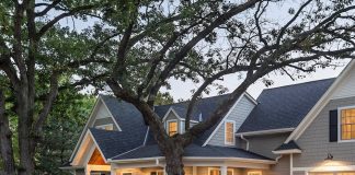 A home with a lit up front porch.