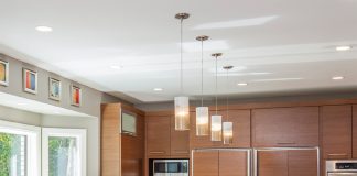 2017 National Kitchen and Bath Association Minnesota Design Awards A large kitchen with a center island with lights hanging over it, and light-wood cabinetry accented by stainless steel appliances, a winner in the 2017 National Kitchen and Bath Association Design Awards.