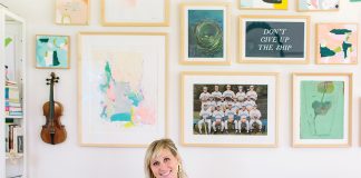 Kate Duininck holds her baby and dog on couch in her Excelsior Home