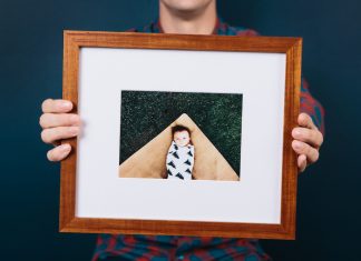 Custom Frames by Framebridge A person holding a newly framed picture from Framebridge.