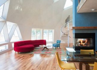 Luxury Super Bowl Rentals A great room with geometric-patterned windows, fireplace, large red sofa and spiral staircase.