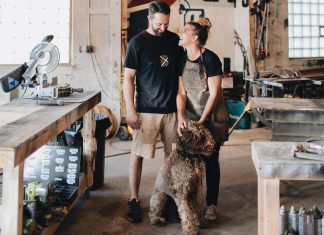 Bailey Builds Anna and Nathanael Bailey of Bailey Builds in their shop with their dog, Oakley.