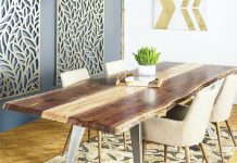 A wood table surrounded by chairs by Timber & Tulip.