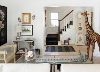 Small Spaces, Big Ideas A living room full of random treasures including a three-legged chair, clock and wooden giraffe.