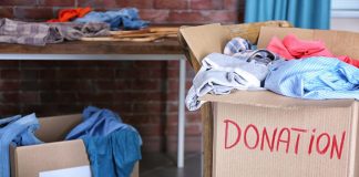 Spring Cleaning Hacks Donation box with clothing on wooden chair