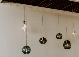 Hennepin Made Expands to North Loop Glass pendants by Hennepin Made hanging from the ceiling.