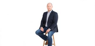 Photo of a man on a wooden stool
