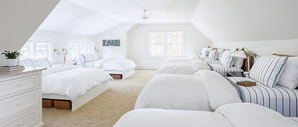 A bunkhouse over a garage with seven beds.