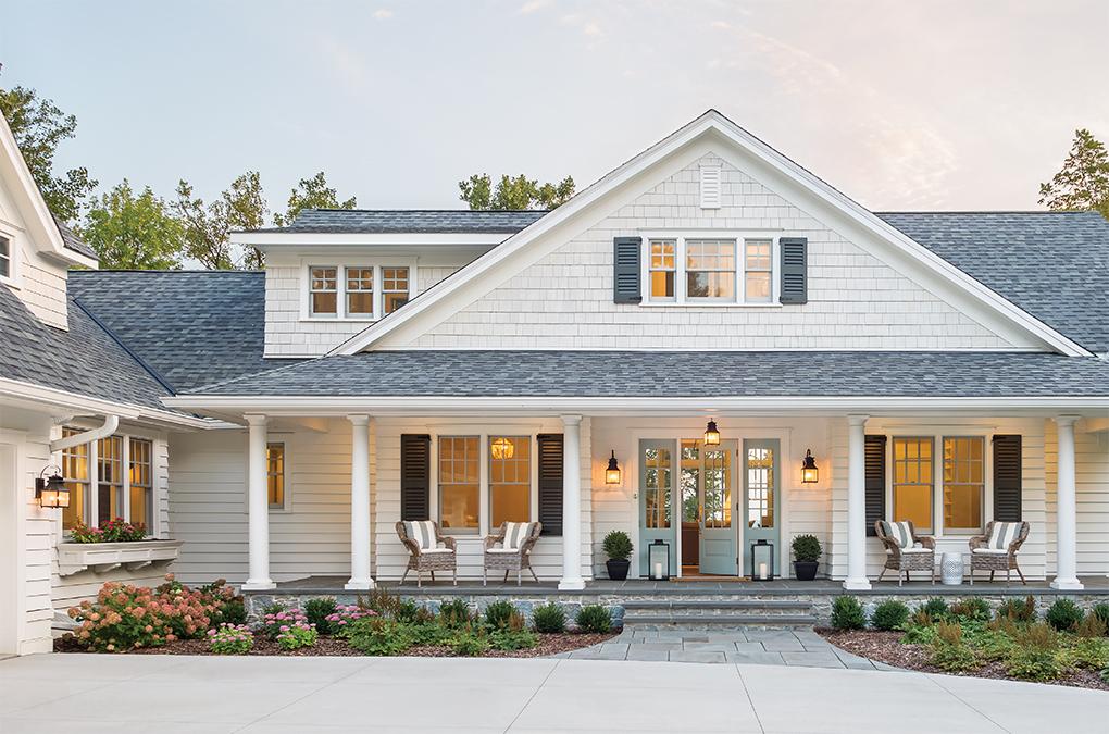 The exterior of a white farmhouse on Lake Pepin in Minnesota.