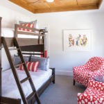 Lake Minnetonka Getaway Made for Entertaining The red bedroom: Each bedroom features an ensuite bath, a white-oak tray ceiling, and a twin and a queen bed.