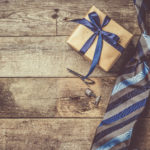 Father’s Day Gifts for Minnesota Dads Father's day concept - present, tie on rustic wood background