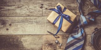 Father's day concept - present, tie on rustic wood background