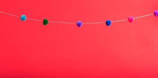 A New Place for Pom Poms Red background with pom pom border