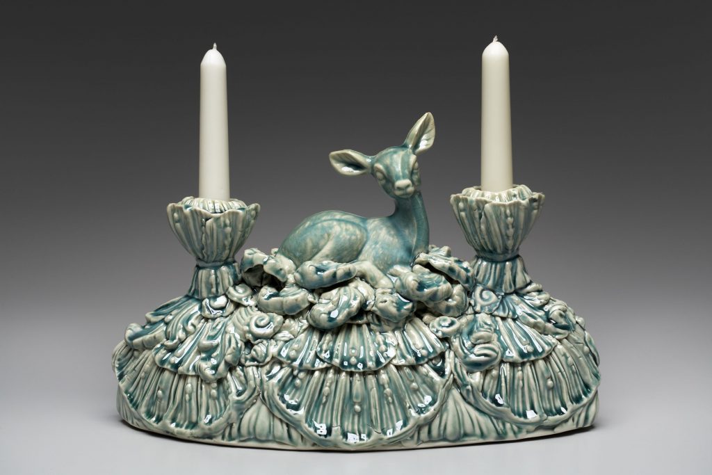 Dual candle holder, in blue green, with deer sitting in grass