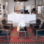 Clio Surfaces’ New Edina Showroom A new showroom for Clio Surfaces displaying a table and chairs and marbler countertop.