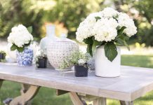 Vases with flowers on a wooden table