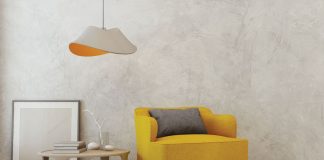 Designer Digs at a Discount A yellow chair sits next to a table and hanging lamp at the 2018 ASID MN sample sale.