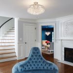 Clean white panels and a glossy dark wood floor provide the perfect backdrop for this elegant, blue-accented space designed by Martha O’Hara Interiors.