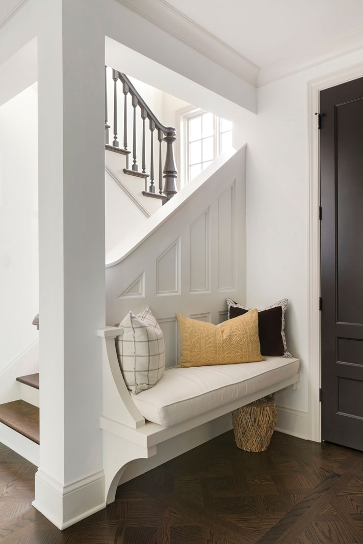 A paneled bench that greets guests when they walk in the front door. Part of the Midwest Home's 2018 Luxury Home Tour.