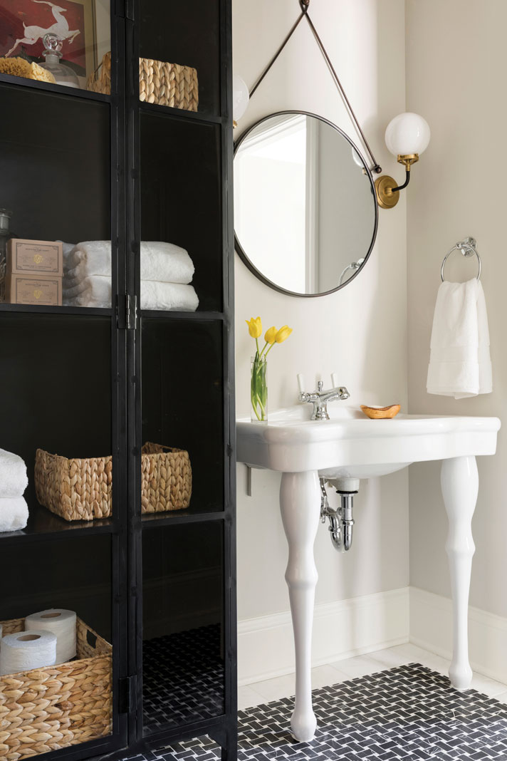the bathroom connecting the two boys’ rooms features a unique, inlaid black marble “rug.” Part of Midwest Home's 2018 Luxury Home Tour.