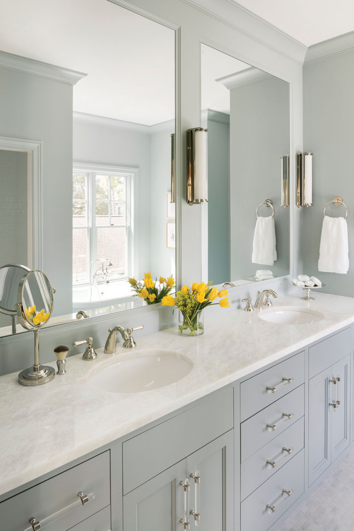 Designed for serenity, the master bath is painted a hazy blue, complementing the putty-colored cabinetry. Part of Midwest Home's 2018 Luxury Home Tour.
