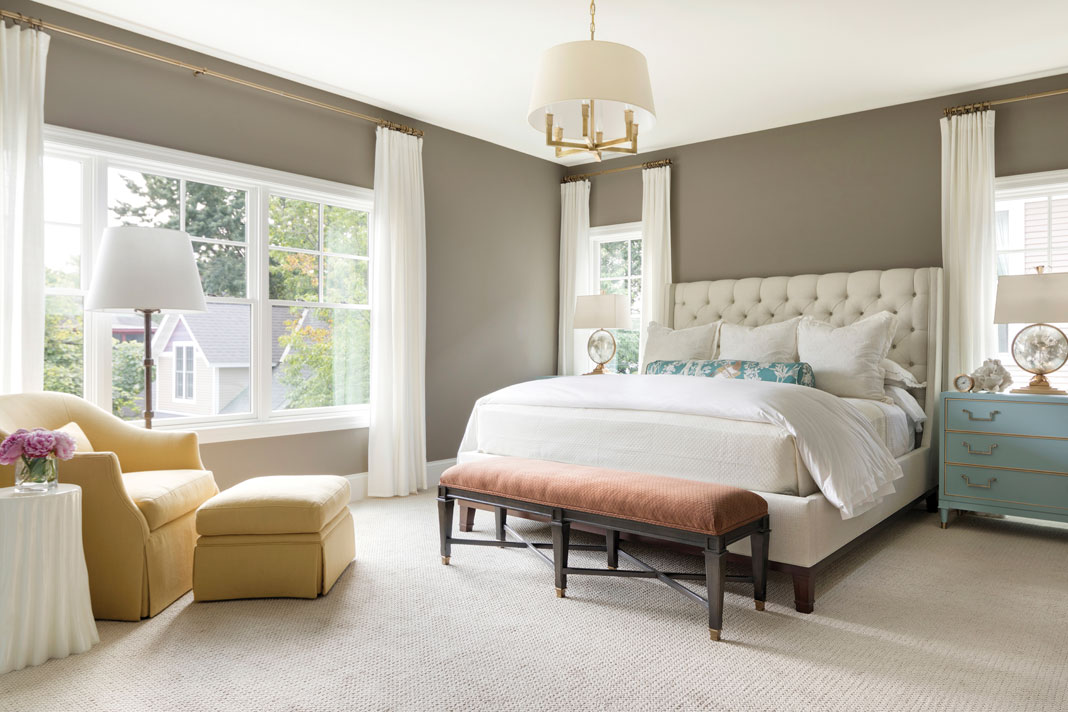 The master bedroom continues the home’s palette of rich colors, with accents of turquoise offsetting the deep warmth of the taupe walls. Part of Midwest Home's 2018 Luxury Home Tour.