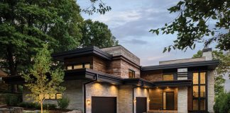 Lakeside Dream Home Built by Stonewood, LLC, this Orono home’s "mountain-modern" exterior combines a contemporary aesthetic with rustic materials, such as reclaimed barn-wood siding paired with dark metal accents. Featured on Midwest Home's 2018 Luxury Home Tour.