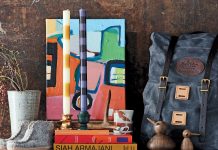 Holiday Gift Guide A dresser with various gifts found in the Holiday Gift Guide placed on top, including shoes, candles, a vase, and more.