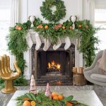 Fresh evergreens, citrus, and faux fur stockings decorate the period fireplace, capturing the spirit of the season and the expert blend of old and new in the stately 1920s Georgian.