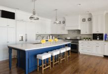 National Kitchen & Bath Association Design Awards A wood floor kitchen with white cabinetry and a pop of blue paint on the island.