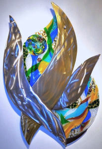 A blue, green, yellow, red, glass and metal wall sculpture