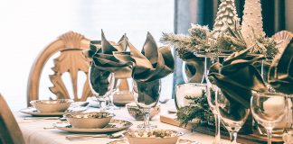 3 Tips for Hosting This Holiday Season A dining table with a green and white holiday tablescape.