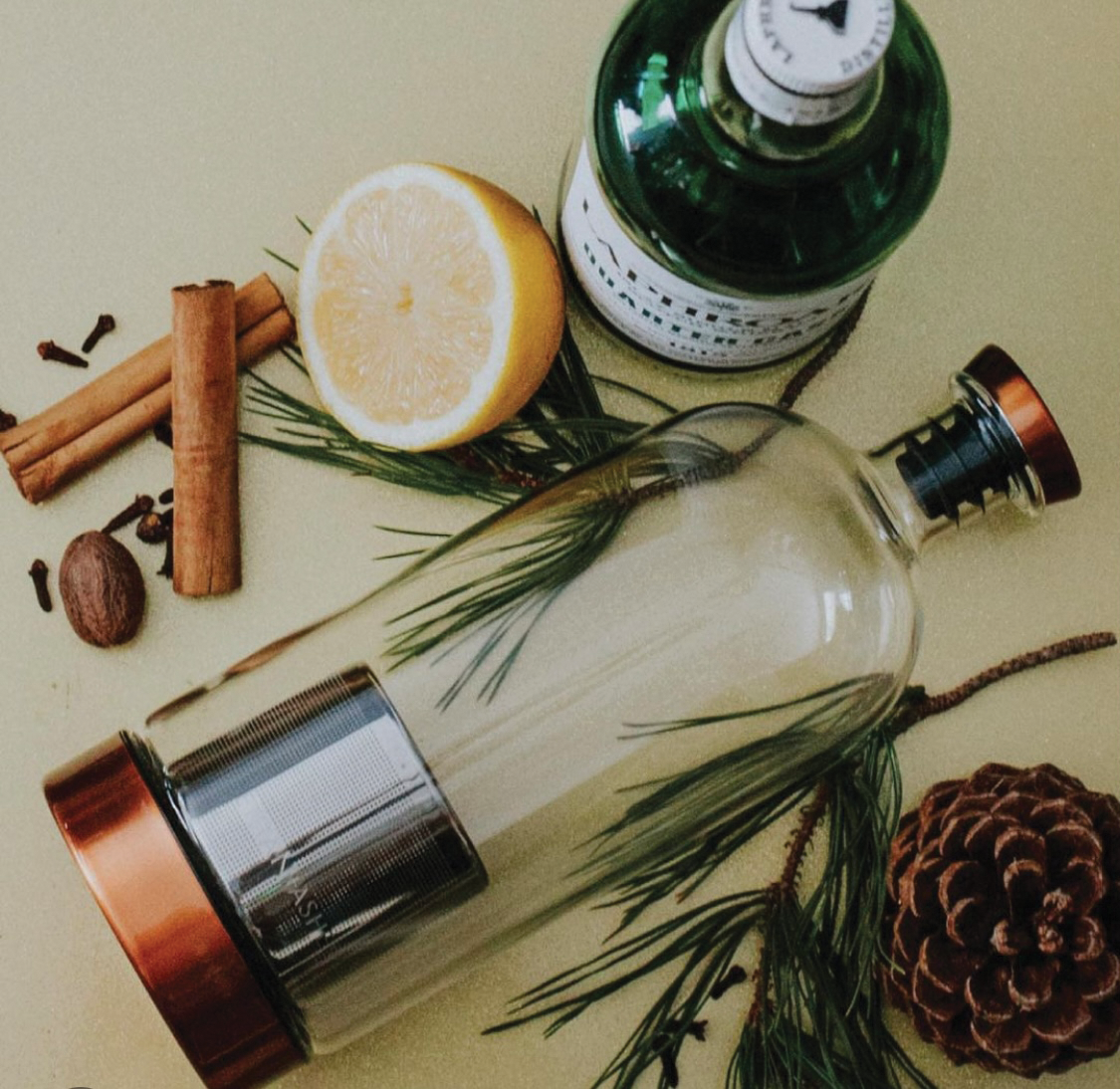 Glass bottle with Pine needles and lemons. 
