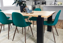 Modern wood table, with dark legs and turquoise dining chairs.