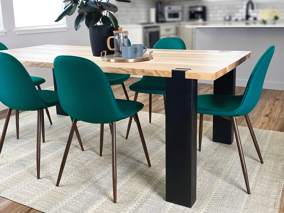 Modern wood table, with dark legs and turquoise dining chairs. 