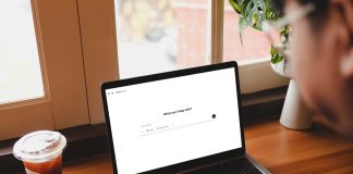 5 Ways Design Professionals Can Use AI erson browsing ChatGPT 4.5 homepage on MacBook Pro in cafe with iced black coffee beside window