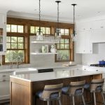 Locking in Clients: 4 Tips to Help Designers Secure Repeat Business This kitchen shines with white countertops and cabinetry paired with wood accents.